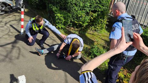 Soccer fan photographs a helpless person